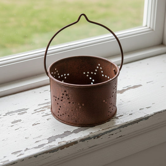 Rusty votive candle holder with a punched star design