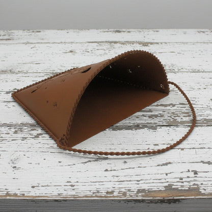 Rusty tin wall pocket with a butterfly punched design