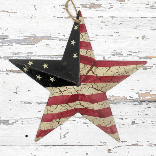 Decorative tin star ornament with American flag design on a wooden background