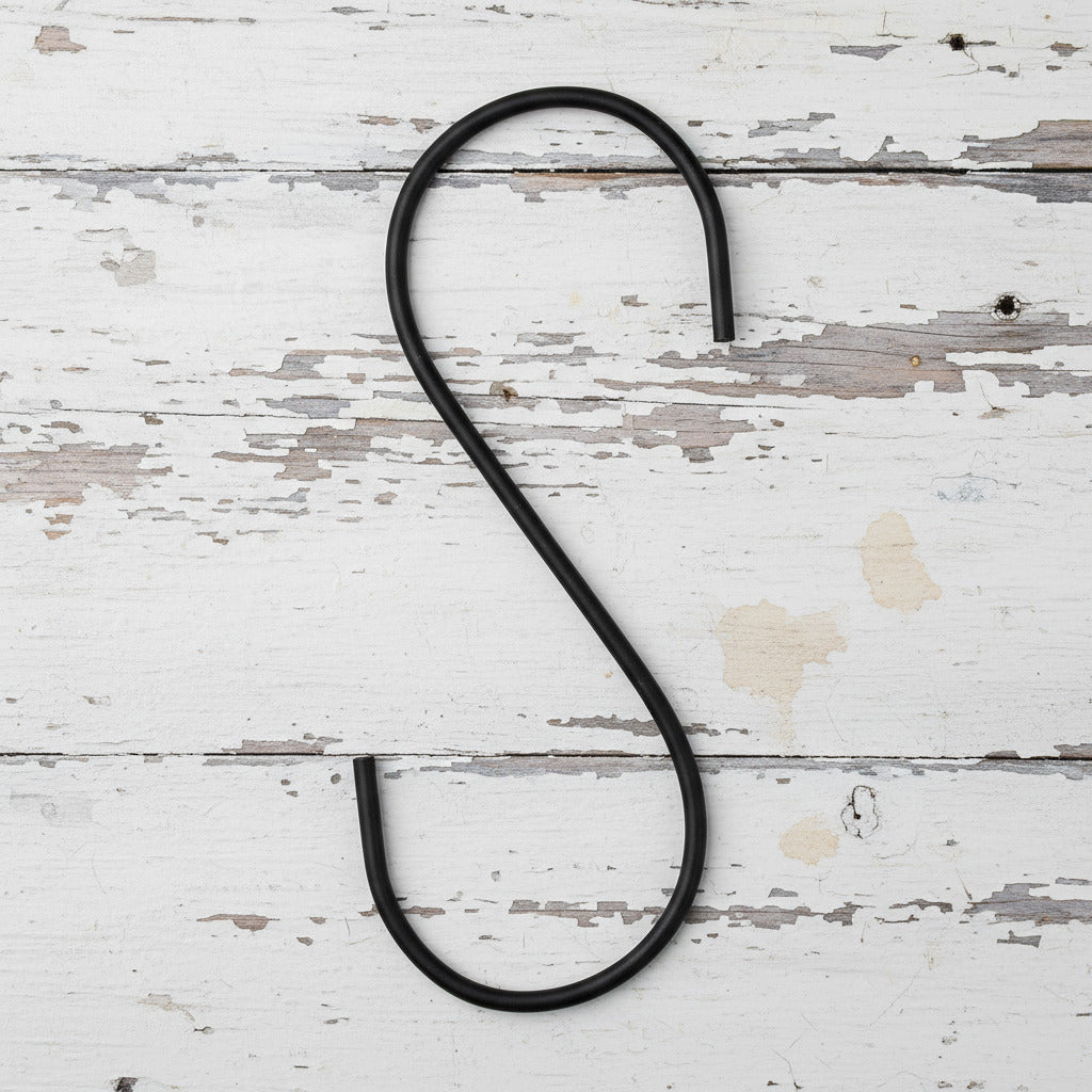 Black metal S-hook on a white background