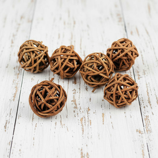 Set of six woven rattan balls on a white background