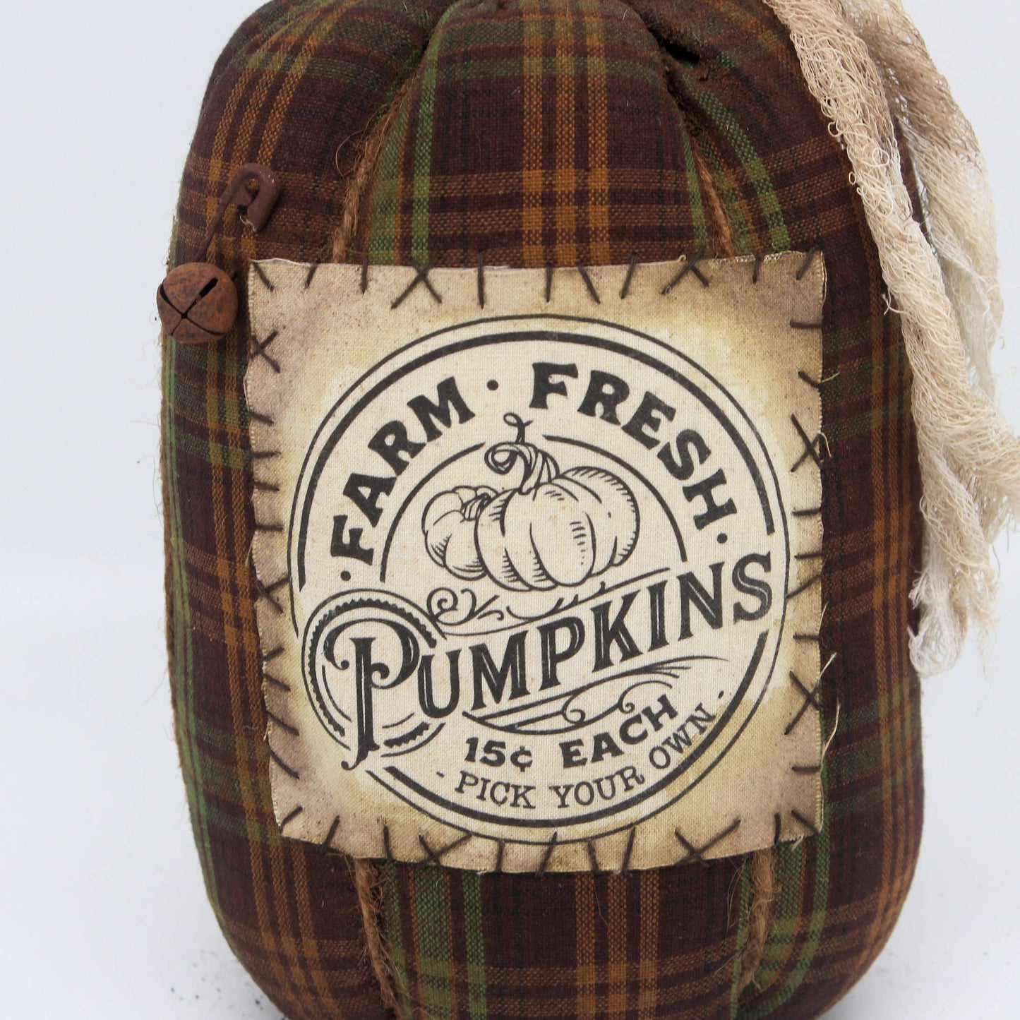 Decorative pumpkin with a plaid pattern and 'Farm Fresh Pumpkins' label on a white background