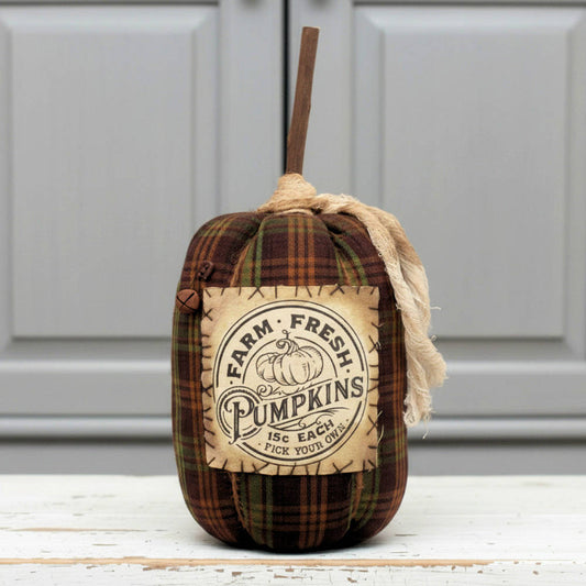 Decorative pumpkin with plaid pattern and 'Farm Fresh Pumpkins' label on a white background