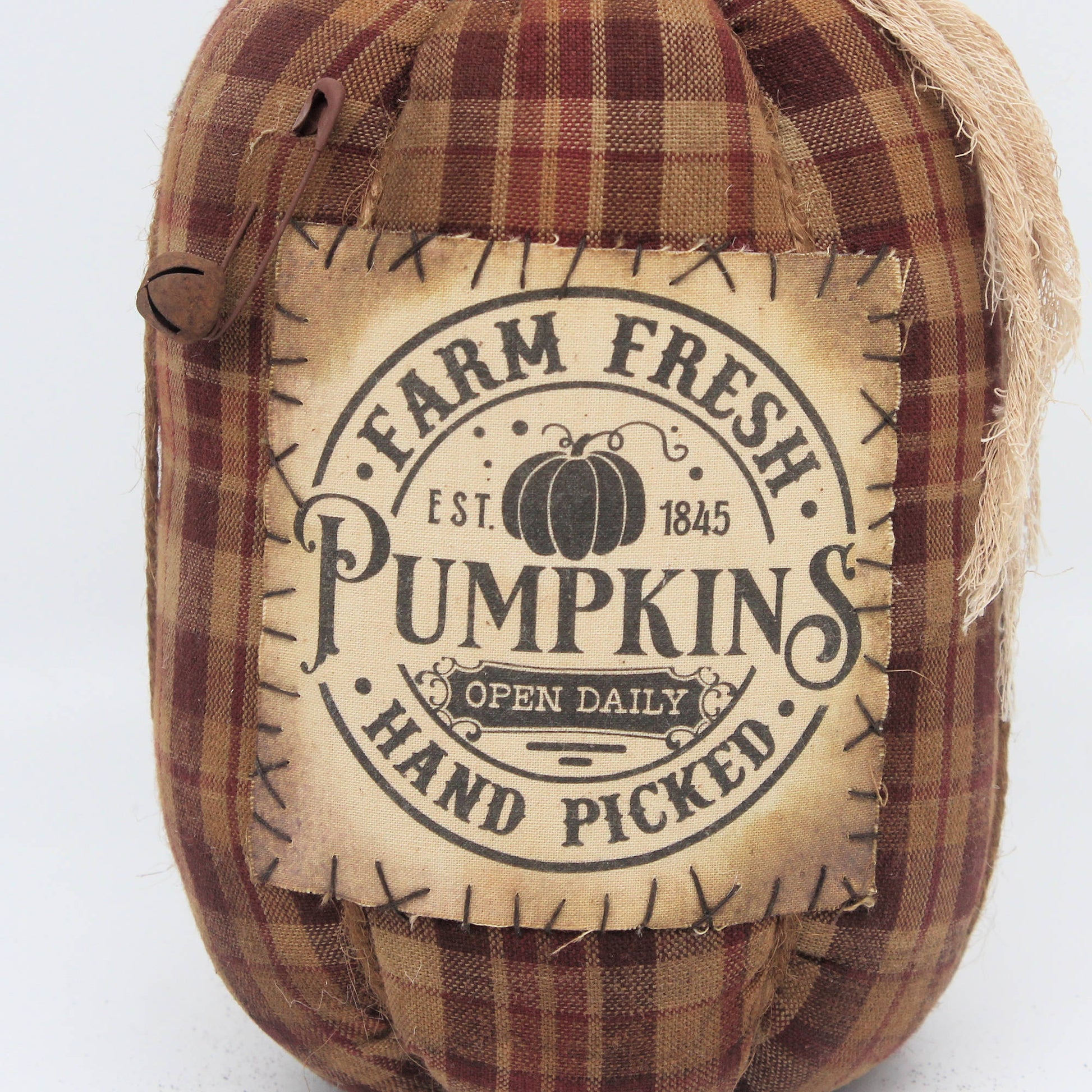 Fabric pumpkin with 'Farm Fresh Pumpkins' label on a white background