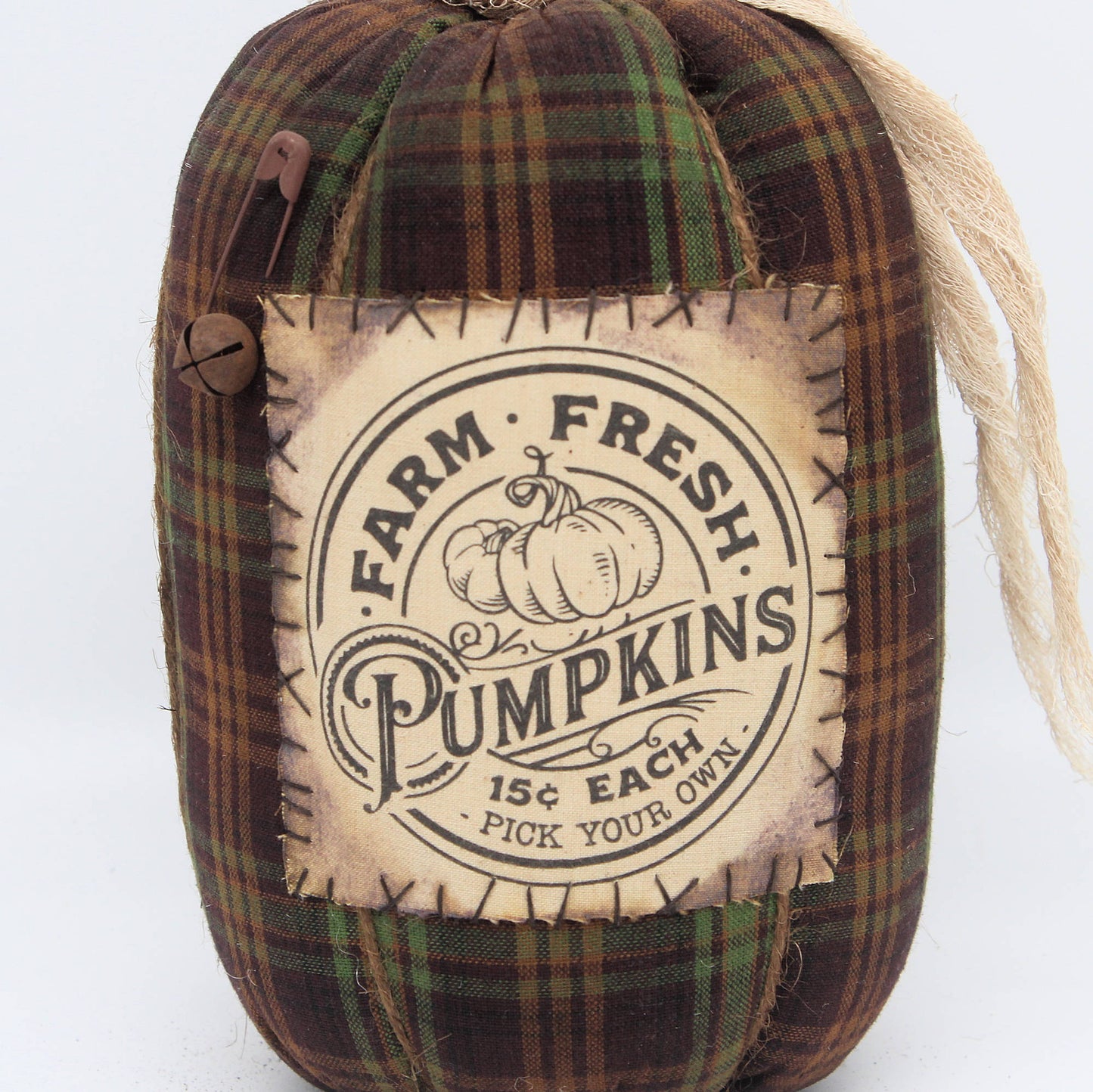 Decorative pumpkin with plaid pattern and 'Farm Fresh Pumpkins' label on a white background