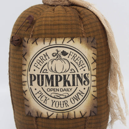Fabric pumpkin with 'Farm Fresh Pumpkins' label on a white background
