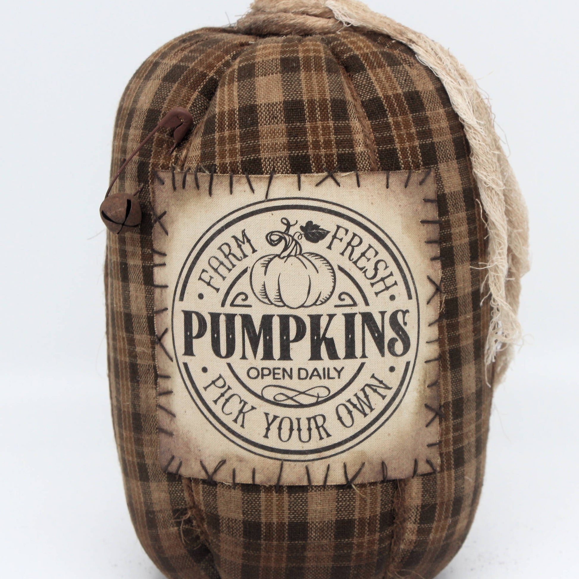 Fabric pumpkin with 'Farm Fresh Pumpkins' label on a white background