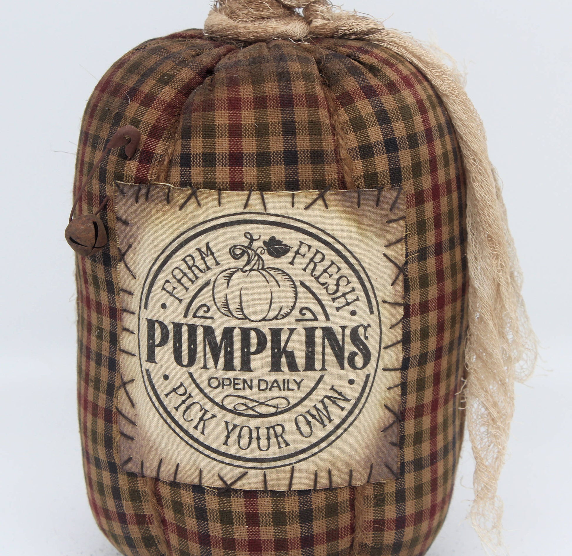 Fabric pumpkin with 'Farm Fresh Pumpkins' label on a white background