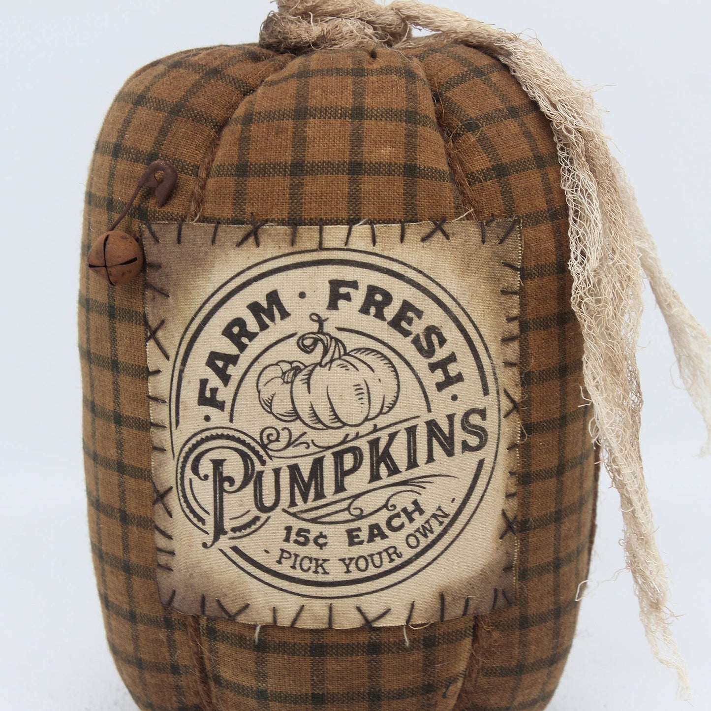 Fabric pumpkin with 'Farm Fresh Pumpkins' text and plaid pattern on a white background