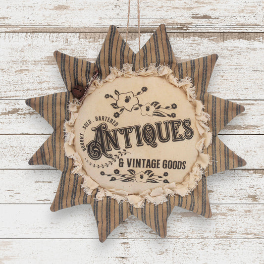 Primitive fabric sunflower ornament with an advertisement for vintage and antiques goods