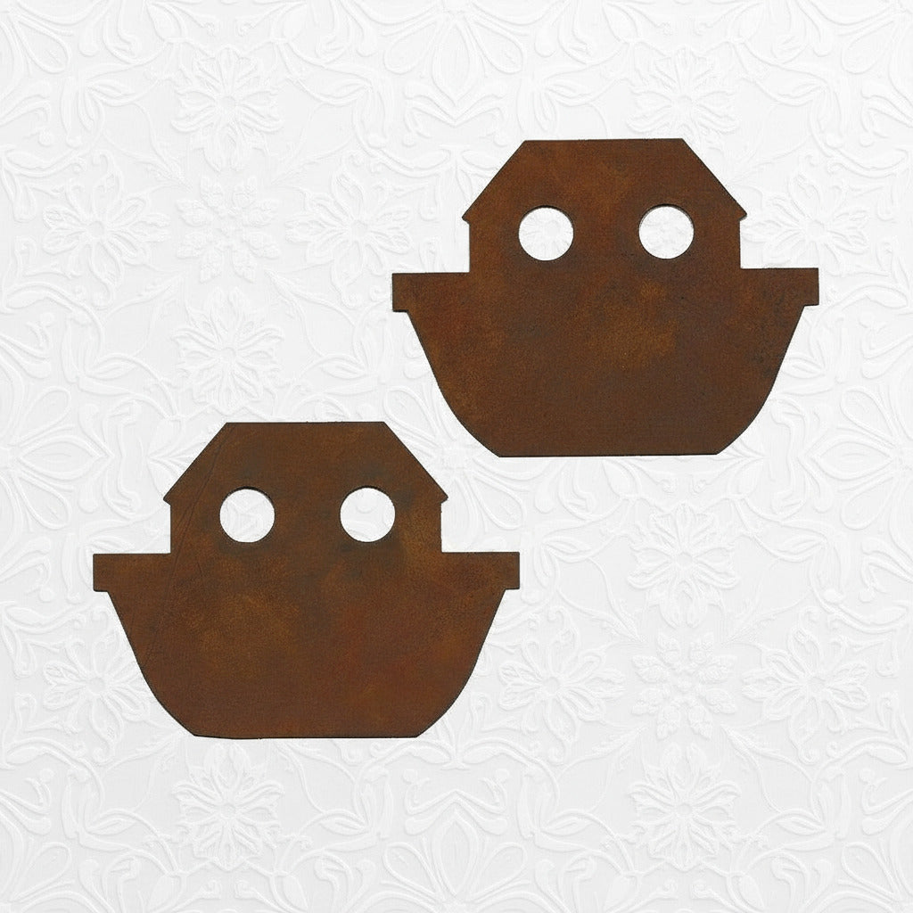 Two rust-colored metal Noah's ark-shaped cutouts on a white background