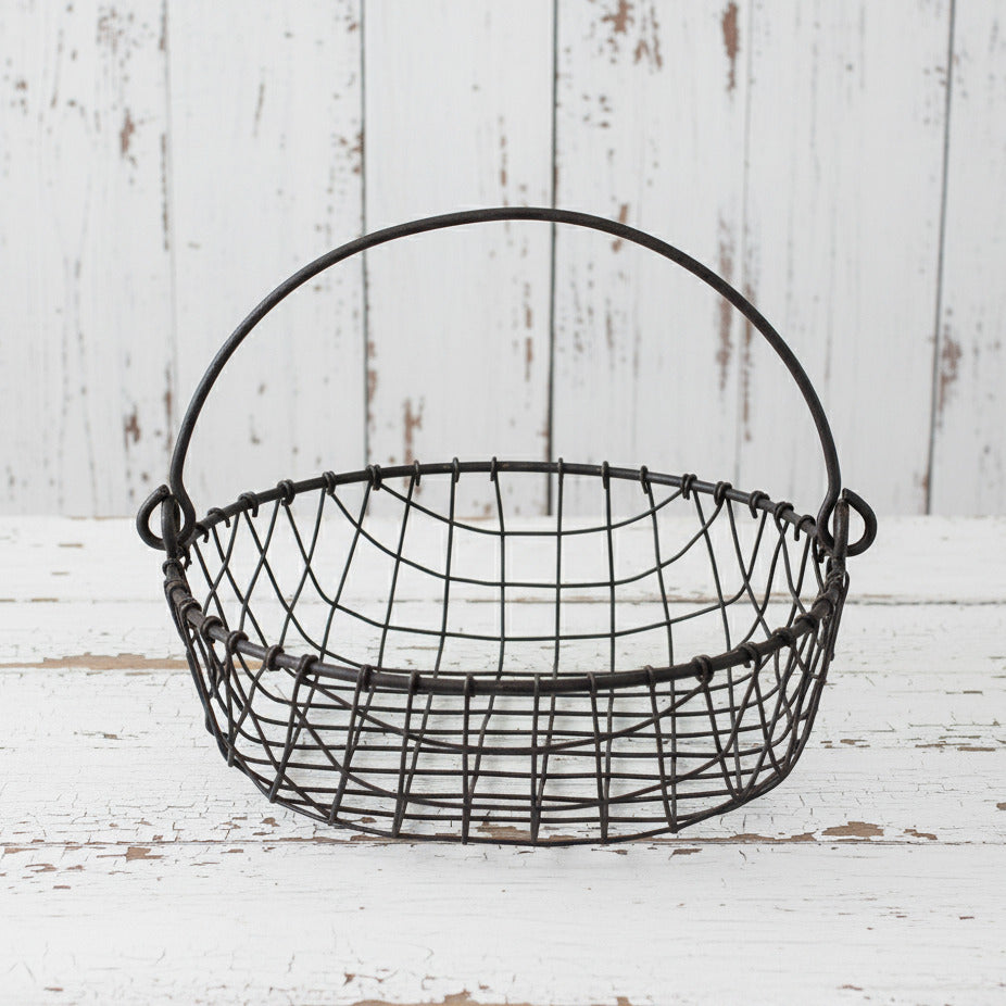 Wire basket with handles on a white background