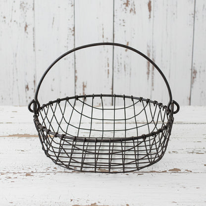 Wire basket with handles on a white background