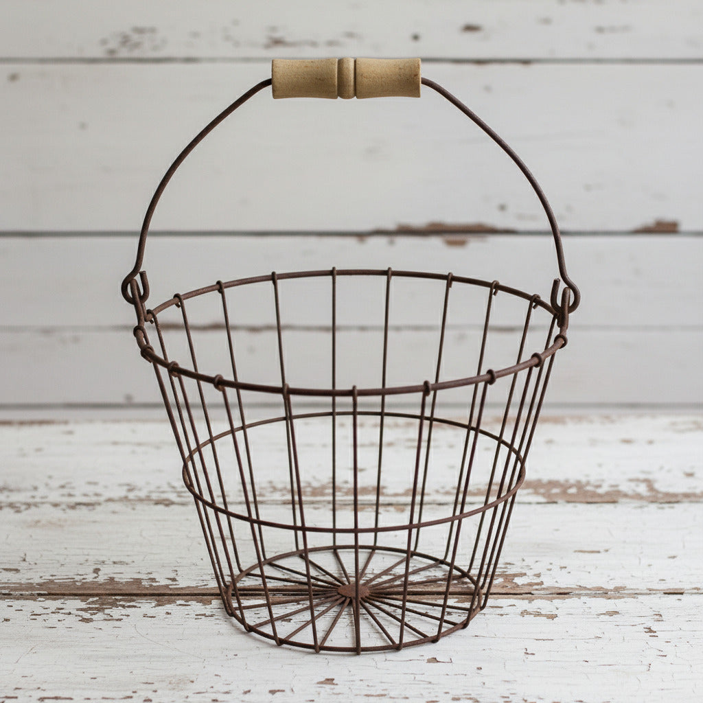 Wire basket with wooden handle on a white background