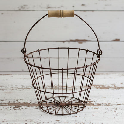 Wire basket with wooden handle on a white background