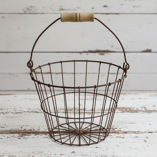 Wire basket with wooden handle on a white background