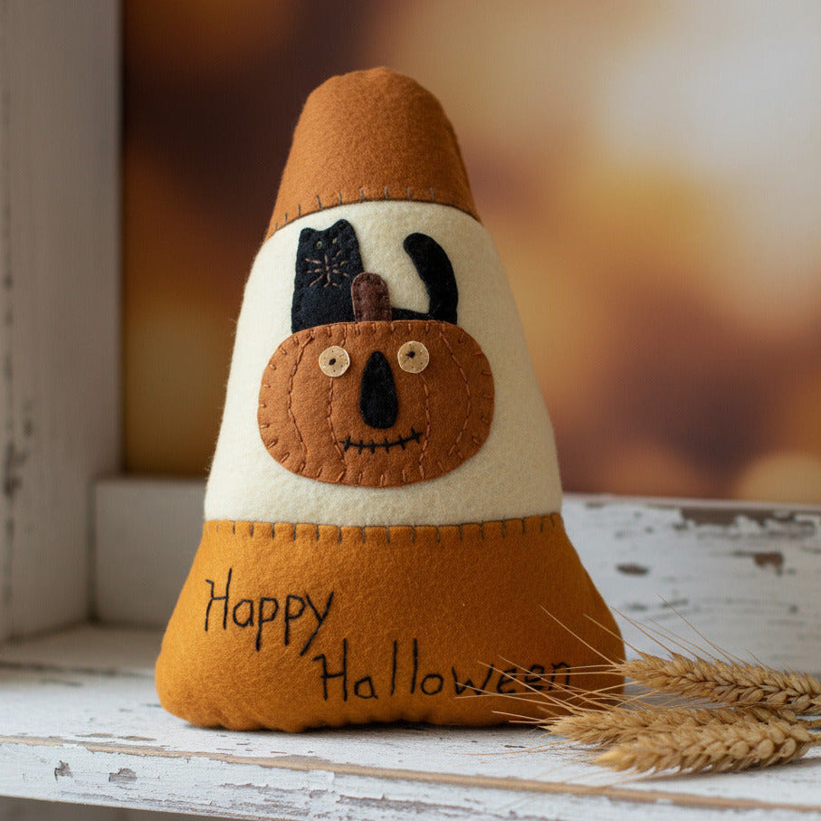 Halloween-themed plush toy with a pumpkin face and 'Happy Halloween' text