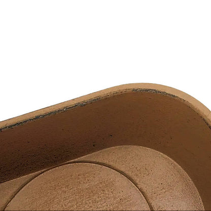 Closeup of a mustard grain scoop candle holder