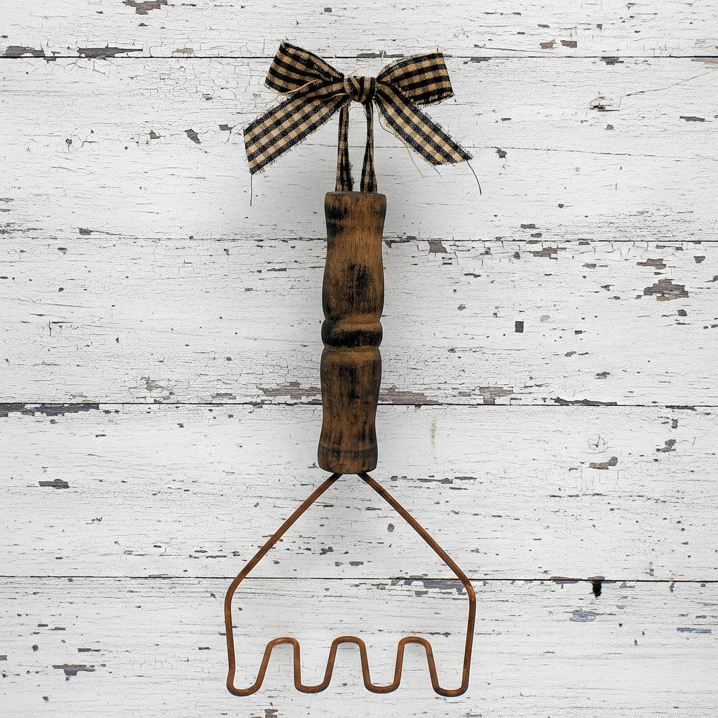 Primitive decorative rusty tin wire potato masher