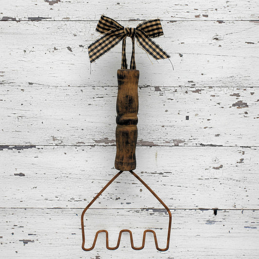 Primitive decorative rusty tin wire potato masher