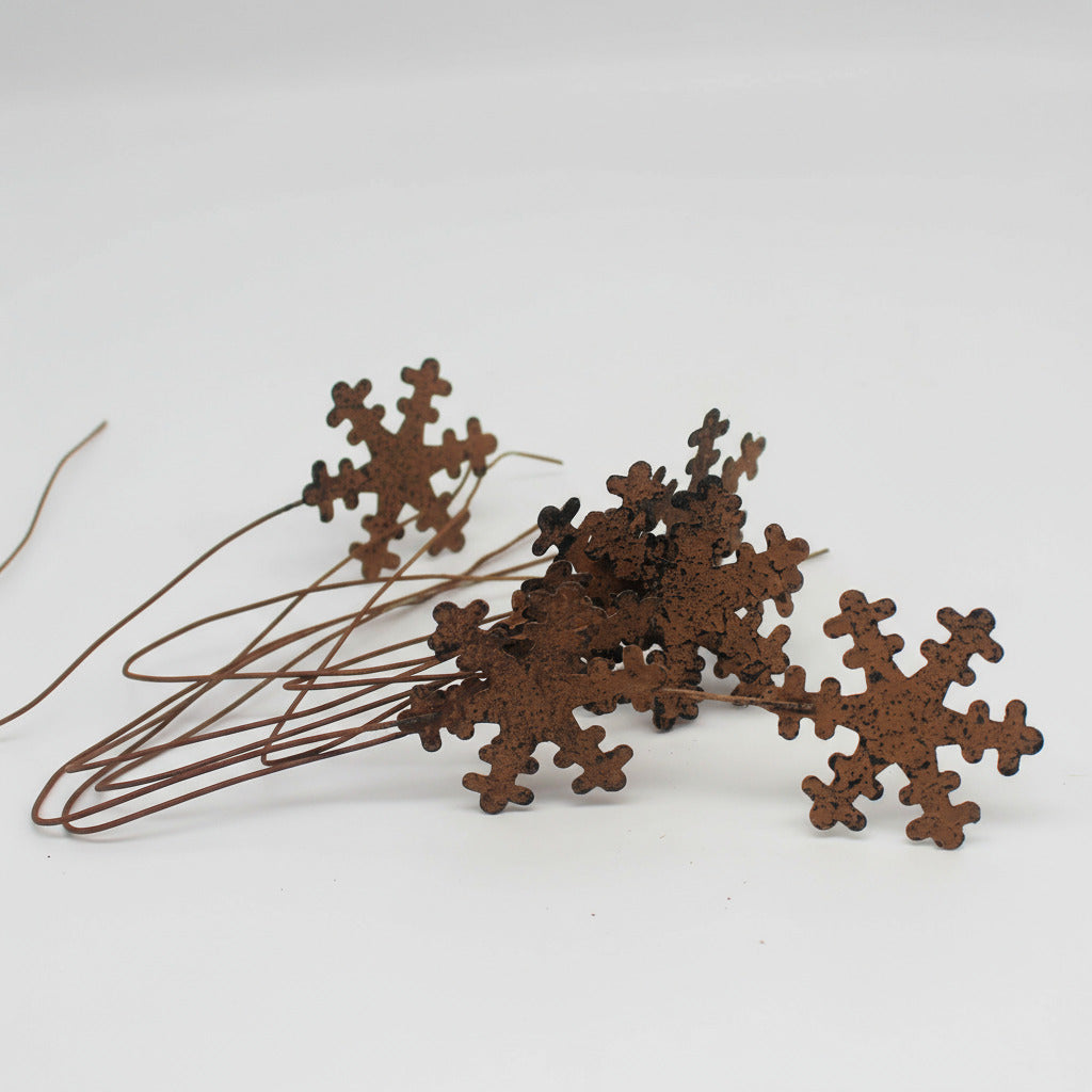 Decorative brown snowflake-shaped picks on a white background