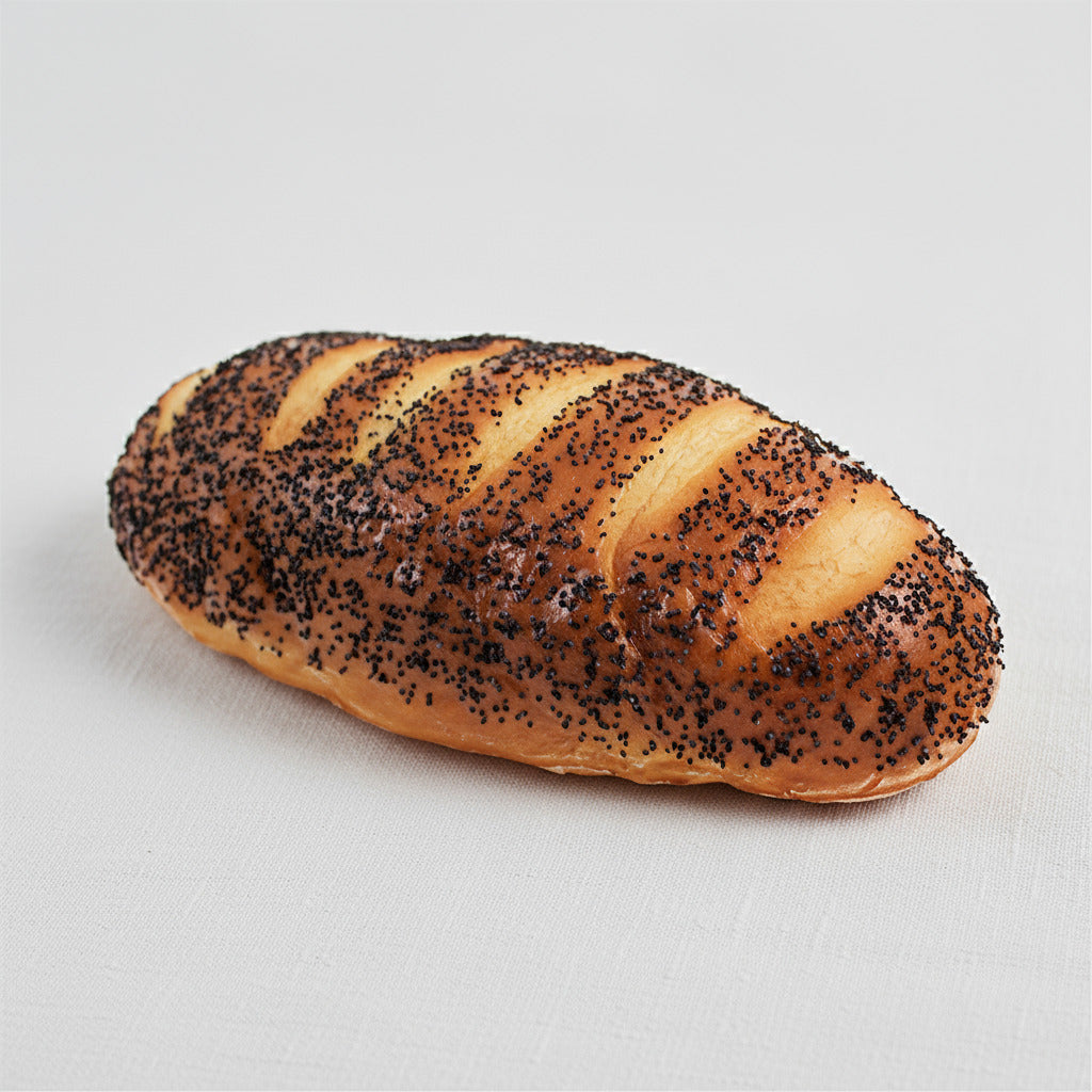 Loaf of fake bread with poppy seeds on a white background