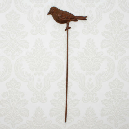 Decorative metal bird stake on a white background