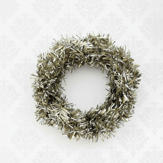 Decorative vintage-style taper candle ring with metallic tinsel on a white background