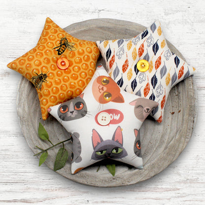 Set of three star-shaped fabric bowl fillers with whimsical cats, feathers and bumblebees designs