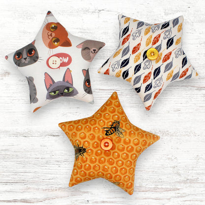 Set of three star-shaped fabric bowl fillers with whimsical cats, feathers and bumblebees designs