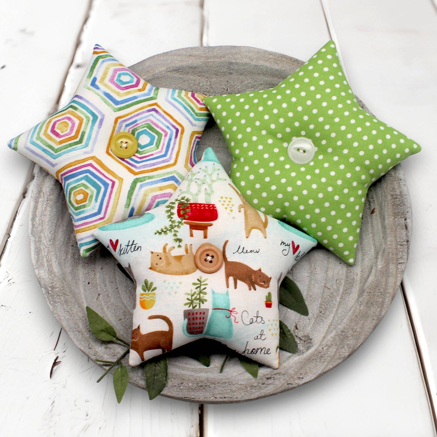 Set of three star-shaped bowl fillers with bright colors and whimsical cats