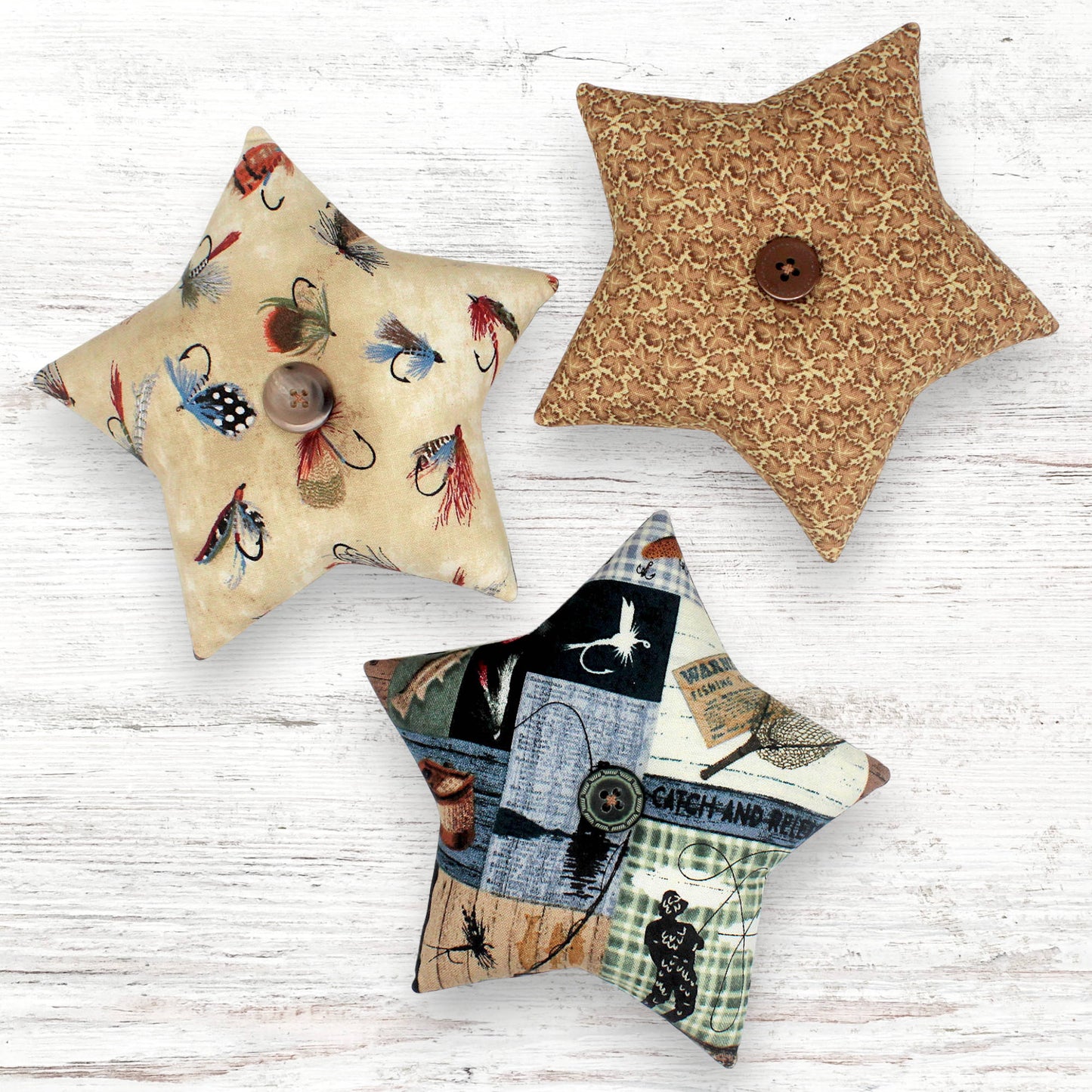 Set of three fabric stars with fishing camp themed designs