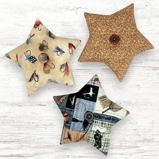 Set of three fabric stars with fishing camp themed designs
