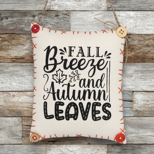 Decorative sign ornament with 'Fall Breeze and Autumn Leaves' text on a wooden background