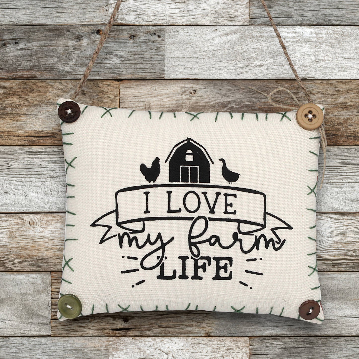 Fabric sign ornament with 'I Love My Farm Life' text on a wooden background