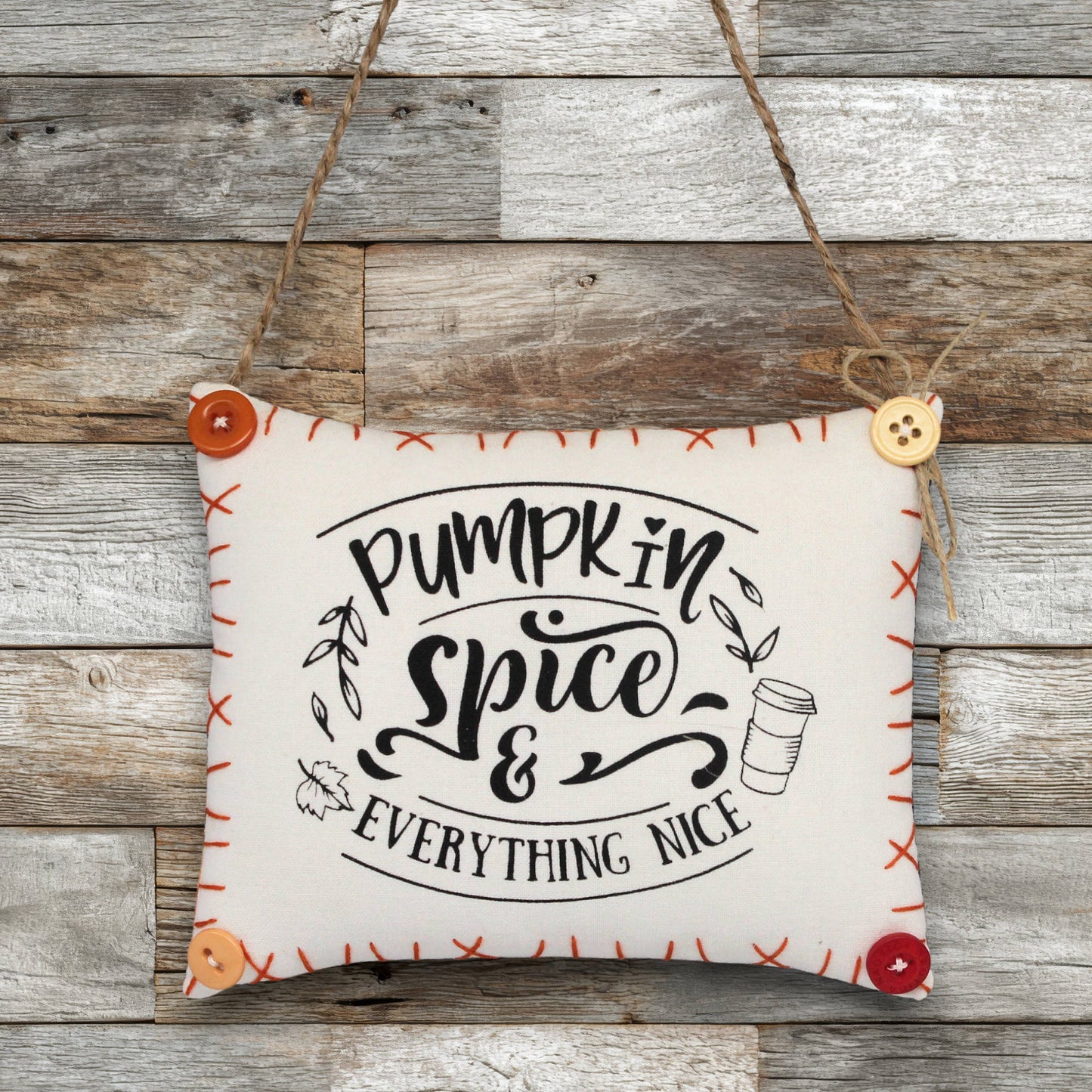 Decorative sign ornament with 'Pumpkin Spice & Everything Nice' text on a wooden background