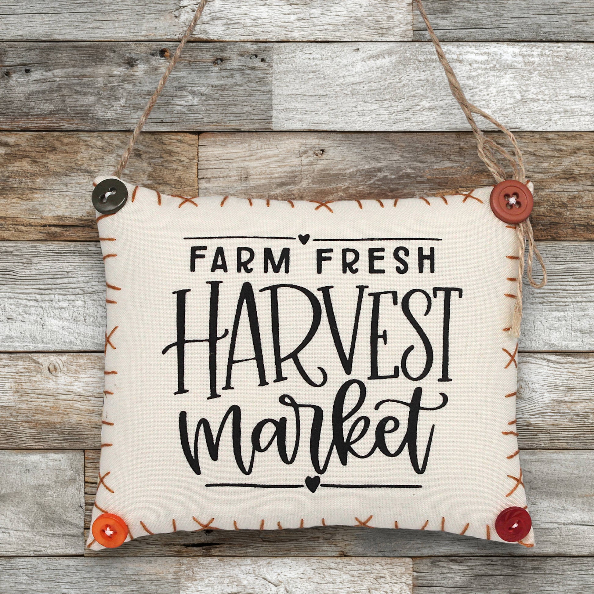 Fabric sign ornament with 'Farm Fresh Harvest Market' text on a wooden background