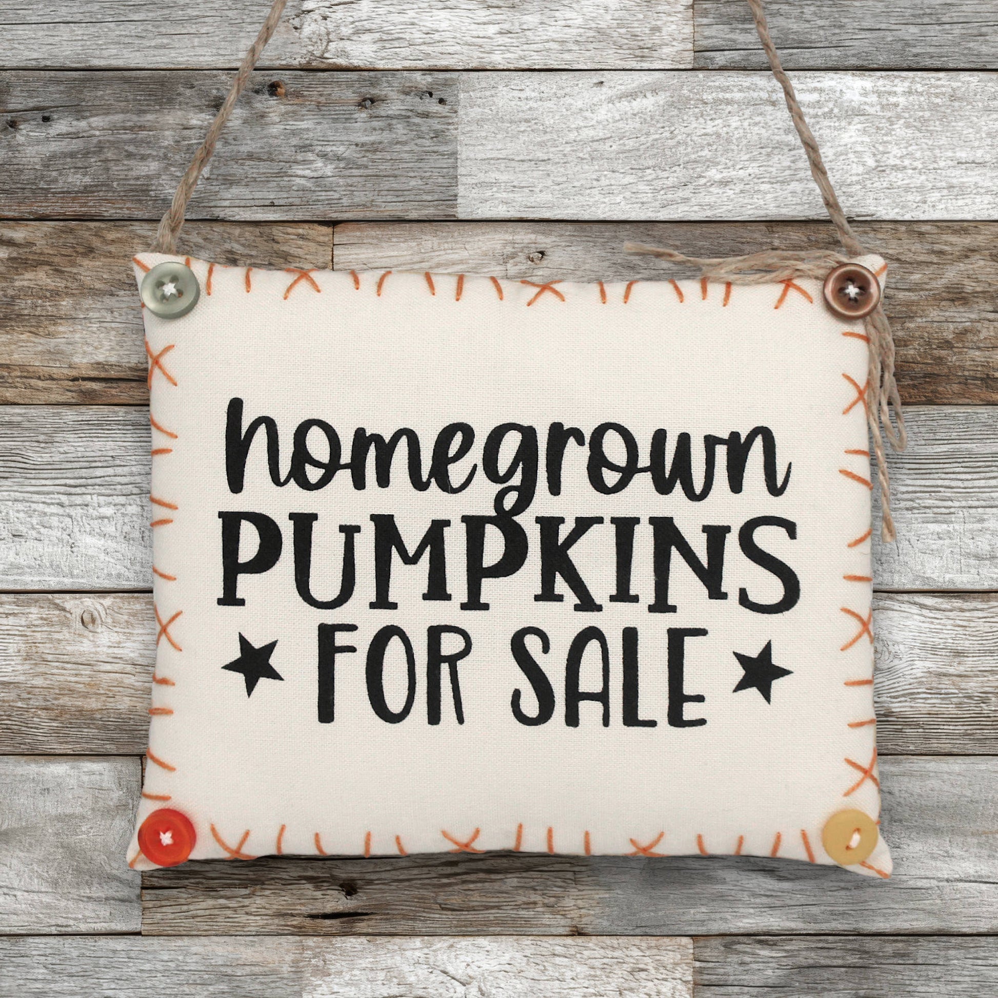 Sign ornament with 'homegrown pumpkins for sale' text on a wooden background