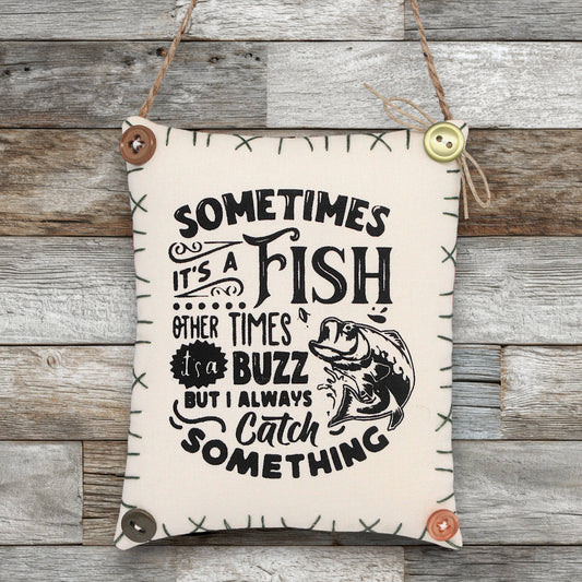 Decorative sign ornament with fishing-themed text on a wooden background