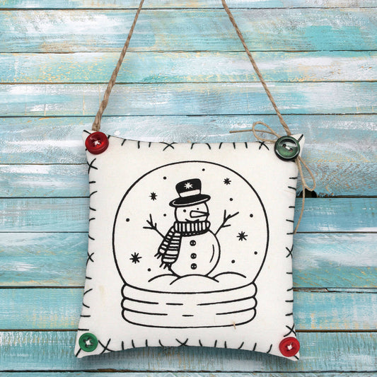 Decorative sign ornament with a snowman design on a wooden background
