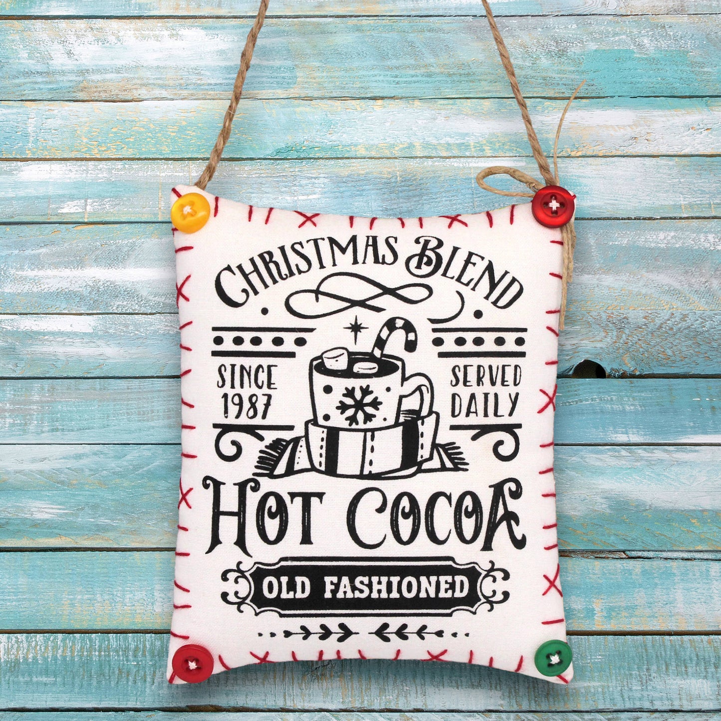 Decorative sign ornament with 'Christmas Blend Hot Cocoa' text on a wooden background