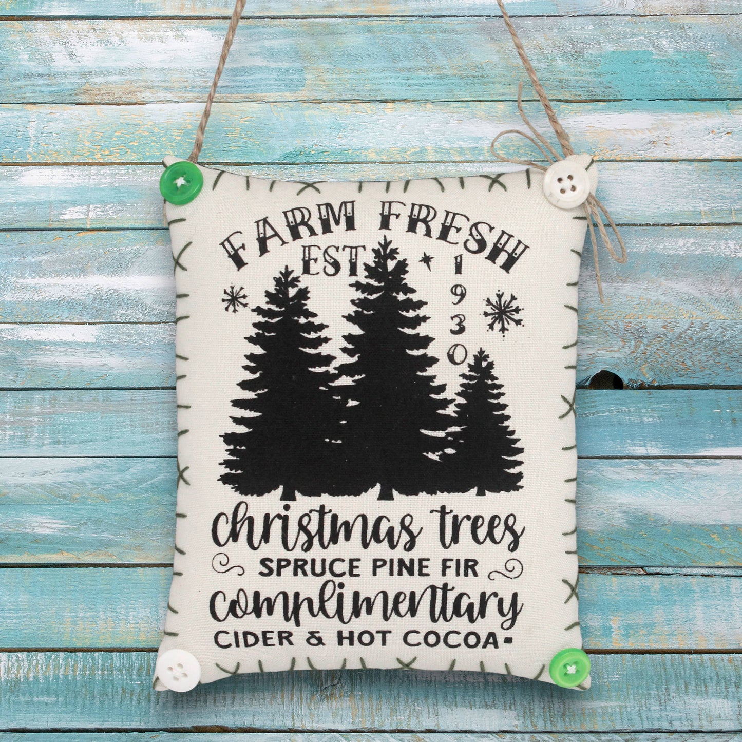 Decorative sign ornament with Christmas tree farm design and text on a wooden background