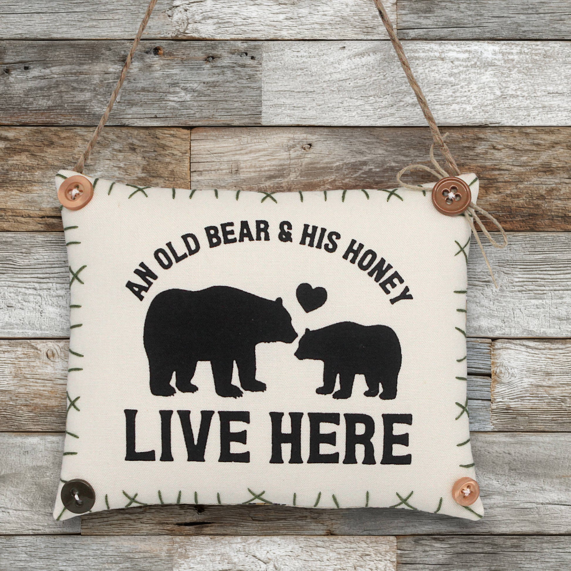 Decorative sign ornament with bears and text 'An Old Bear & His Honey Live Here' on a wooden background