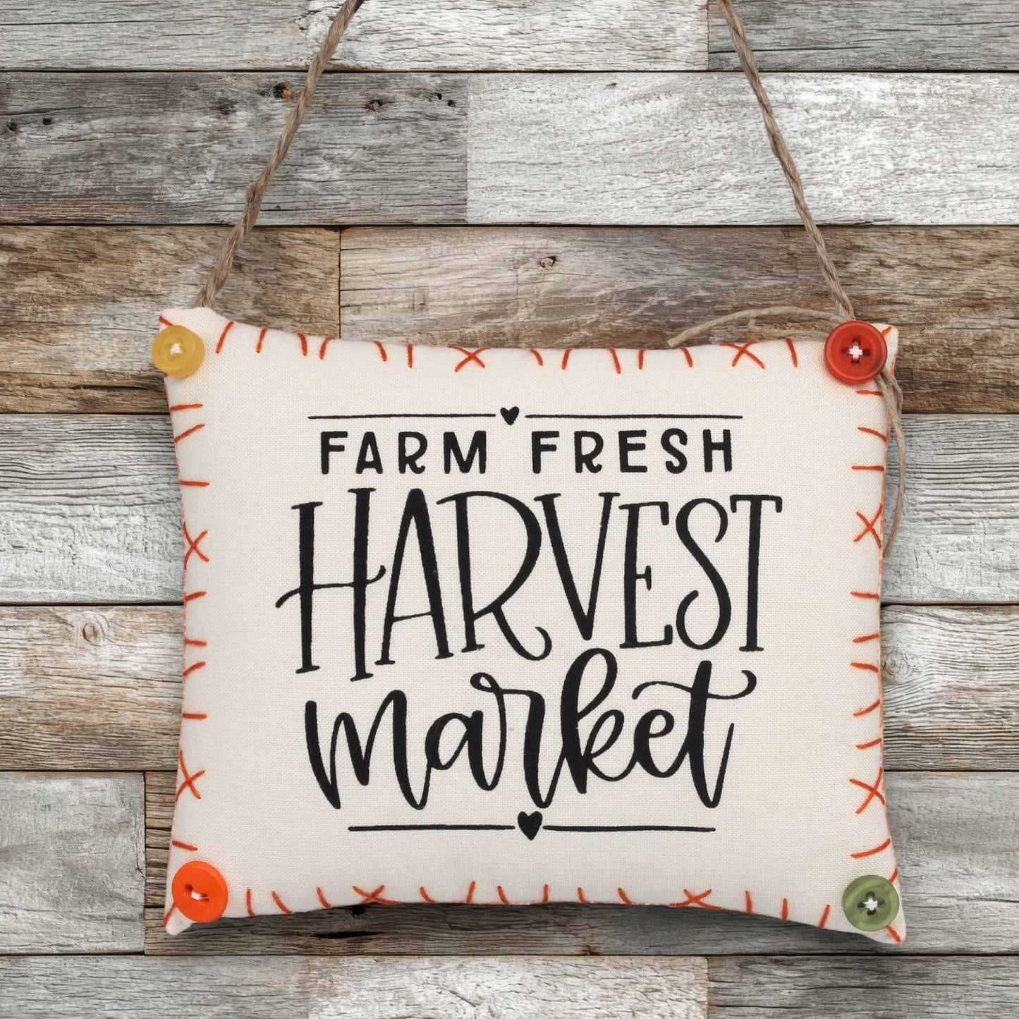 Fabric sign ornament with 'Farm Fresh Harvest Market' text on a wooden background