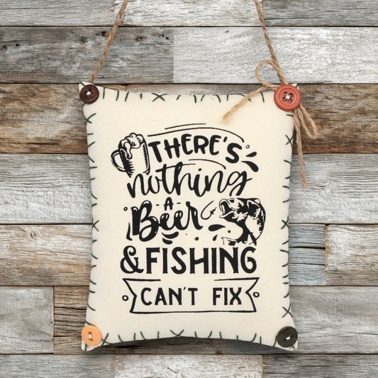 Fabric sin ornament that reads 'there's nothing a beer and fishing can't fix'