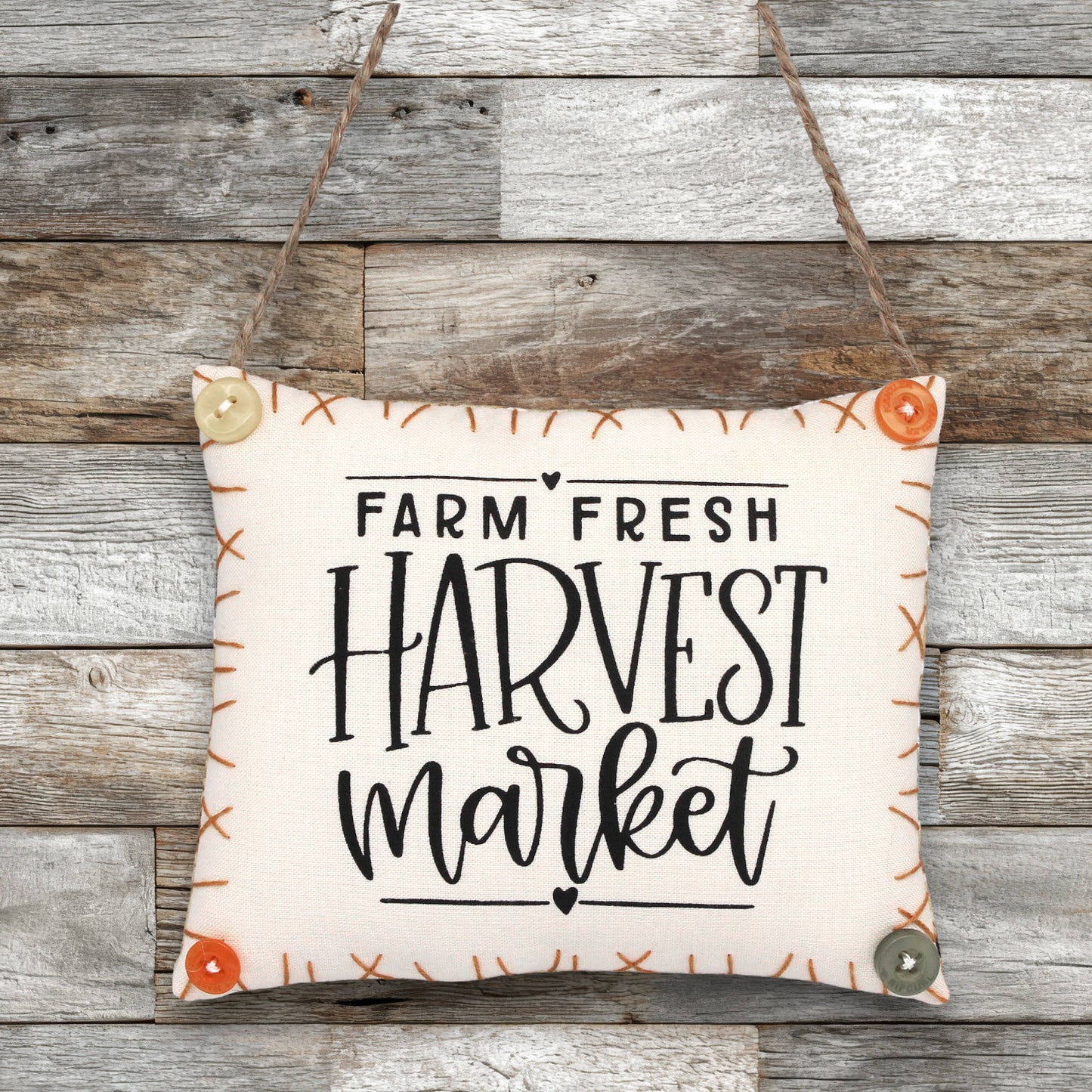 Decorative sign ornament with 'Farm Fresh Harvest Market' text on a wooden background