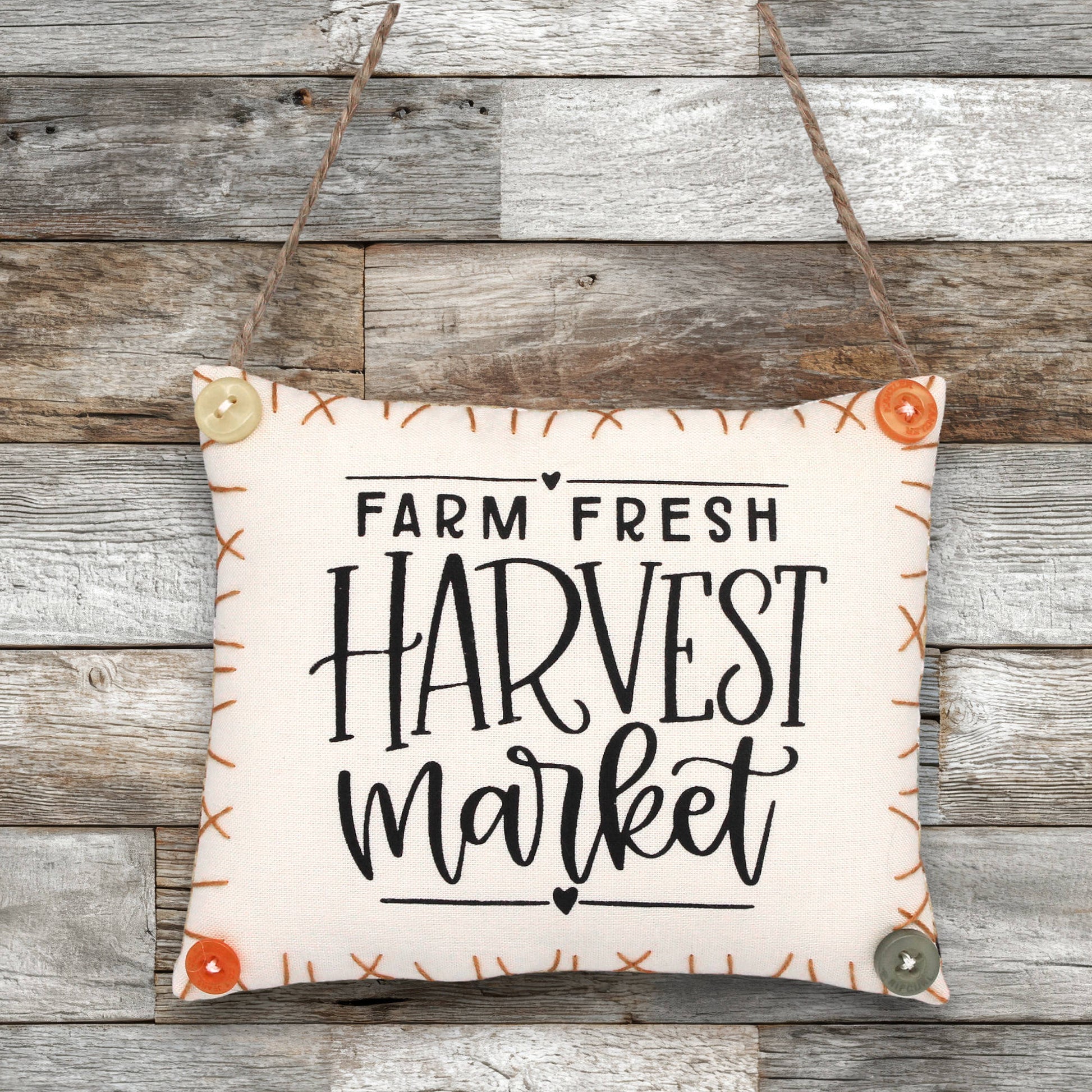 Decorative sign ornament with 'Farm Fresh Harvest Market' text on a wooden background