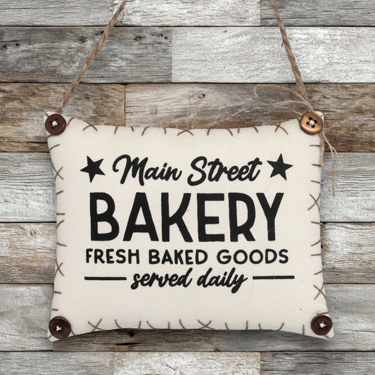 Sign ornament for Main Street Bakery on a wooden background
