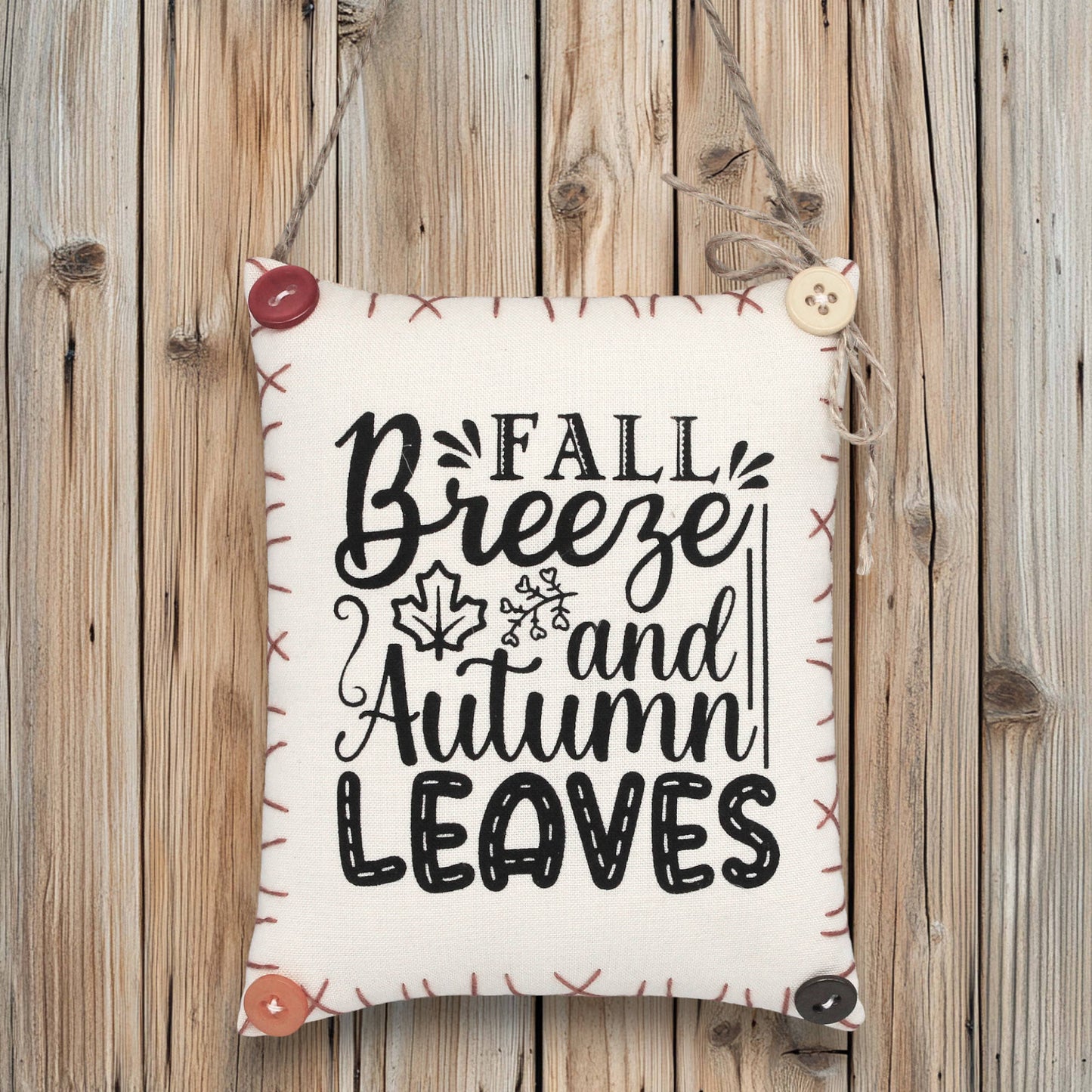 Decorative sign ornament with 'Fall Breeze and Autumn Leaves' text on a wooden background