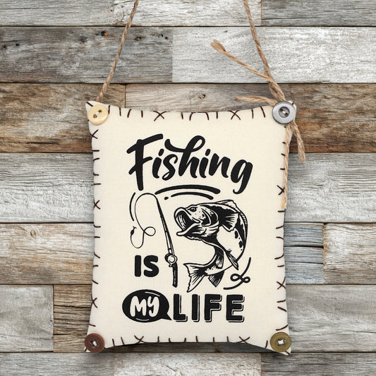 Fabric sign ornament that reads 'fishing is m life'